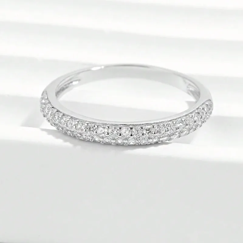 Silver ring with small diamonds on a white background
